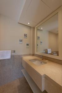 a bathroom with a large mirror and a sink at Joubal 3BR Villa Private Pool next to Marina in Hurghada