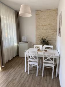 a dining room with a white table and chairs at Guest House Piatra Craiului in Bran
