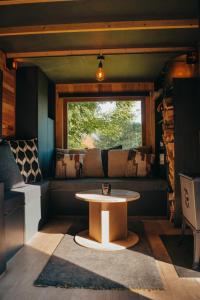 a coffee table in a room with a window at Tiny House Célestine By Ernesst in Overijse