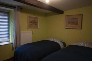 a bedroom with two beds and a window at Le bateau ivre in Fumay