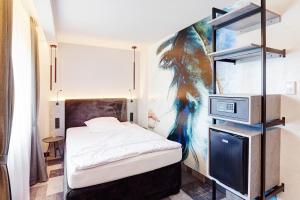 a small bedroom with a bed and a tv at Hotel Stadt Grevenbroich mit Klimaanlage in Grevenbroich