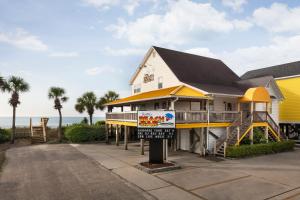a house with a play house with a sign in front of it at Surfside Beach Oceanfront Hotel in Myrtle Beach