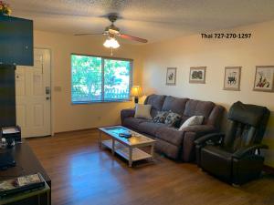 a living room with a couch and a table at House 3br 1-bath, 8-min from Indian Rocks Beach, nice park thru back gate in Largo