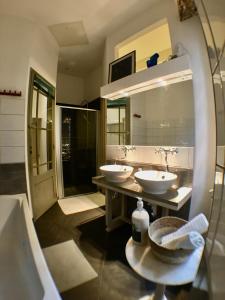 a bathroom with two sinks and a large mirror at Bauhaus Saint-Pierre in Gaillac