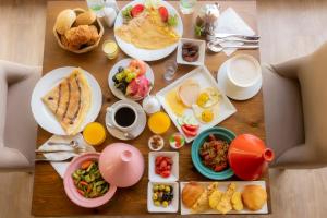 una mesa cubierta con platos de comida y bebida para el desayuno en Hôtel Rembrandt, en Tánger