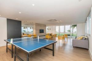 a living room with a ping pong table in it at Atlântida Green Square - 606B in Xangri-lá