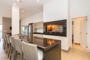 a kitchen with a counter with a fireplace at Atlântida Green Square - 607A in Xangri-lá