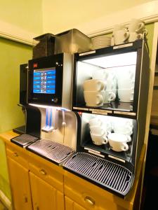 a refrigerator filled with cups and dishes on a counter at Hotel Hansehof in Hamburg