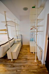 a room with four bunk beds and wooden floors at Summerland Happy Blue Apartments in Mamaia