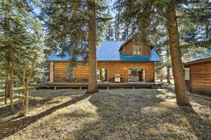 a log cabin in the woods with trees at Bayfield Cabin with Wraparound Deck and Fire Pit in Bayfield
