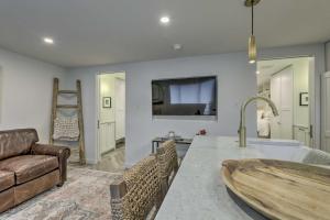 a kitchen with a living room with a couch and a table at Aspen Condo with Mountain Views and Ski Access! in Aspen