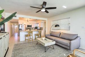 a living room with a couch and a table at Cute and Cozy Florida Duplex Walk to Beaches! in Cocoa Beach