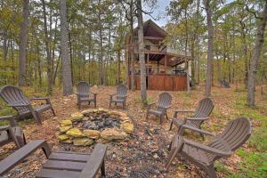 a group of chairs around a fire pit with a cabin at Tudor-Style Cottage with 2 Decks and Hot Tub! in Stephens Gap