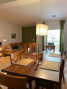 a dining room and living room with a wooden table at Apartment Andrea in Trebinje