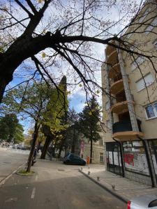 a street with a building and a car parked on the street at Apartment Andrea in Trebinje