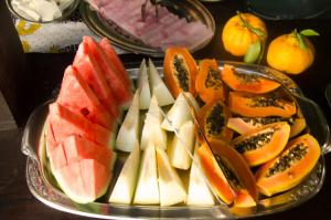 a tray of fruit on a table with a plate at Pousada Solar do Algarve in Paraty