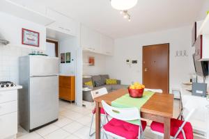 a kitchen and dining room with a table and chairs at Firenze Nova Comfortable Apartament with Terrace in Florence