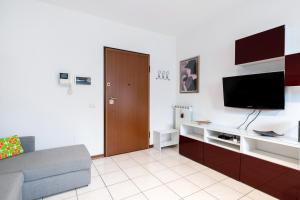 a living room with a couch and a flat screen tv at Firenze Nova Comfortable Apartament with Terrace in Florence
