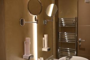 a bathroom with a mirror and a sink at Hotel Bell'arrivo by Dori in Peschiera del Garda