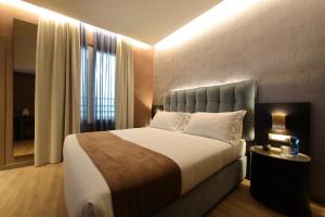 a bedroom with a large bed and a window at Hotel Bell'arrivo by Dori in Peschiera del Garda