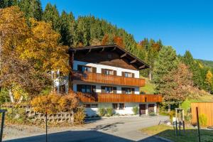 an apartment building in the mountains with trees at Ferienwohnung Marlies in Bartholomäberg