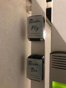 two soap boxes on a wall with the words return sea at Sea fly guest house in Fiumicino