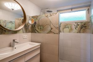 a bathroom with a sink and a mirror at Ferienwohnung Marlies in Bartholomäberg +9 photos