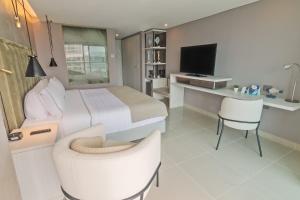 a bedroom with a bed and a desk and a tv at Sonesta Hotel Cartagena in Cartagena de Indias