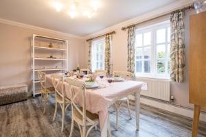 a dining room with a table and chairs at 1 Sanctuary Court - Aldeburgh Coastal Cottages in Thorpeness