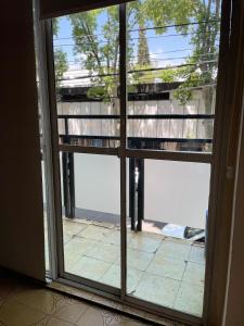 an open glass door with a view of a patio at Piazza Suites 2 in Mendoza