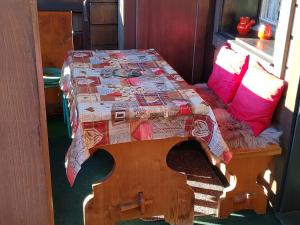 a table with a quilt on it in a room at Studio avec vue splendide sur les Diablerets in Les Diablerets