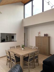 a dining room with a wooden table and chairs at Apartment de Kerk in Sint-Gillis-Waas