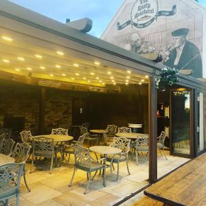 a patio with tables and chairs in front of a restaurant at The Rusty Mackerel in Teelin