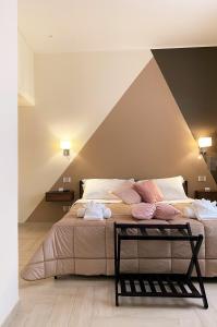 a bedroom with a large bed with pink pillows at B&B De Nava Suite in Reggio Calabria