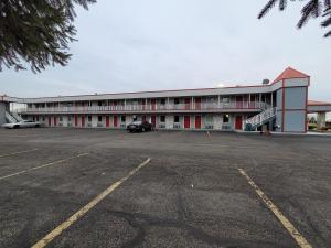 a parking lot in front of a large building at Relax Inn in Marshall