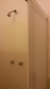 a shower with a shower head in a bathroom at Pension Zocalo in Mexico City +23 photos