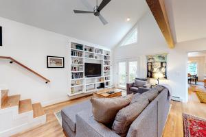 a living room with a couch and a tv at Old Town Cottage in Steamboat Springs