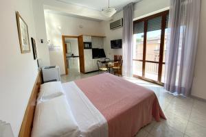 a bedroom with a large bed and a dining room at Majestic Suite in San Benedetto del Tronto +15 photos