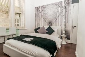 a bedroom with a large bed with a painting on the wall at Hotel Nineteen in Brighton & Hove