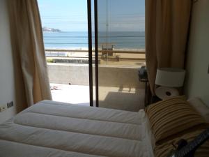 Postel nebo postele na pokoji v ubytování Departamento Frente al Mar + 28 fotografií