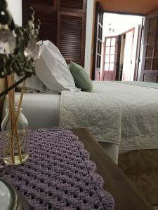 a bedroom with a bed and a table with a purple rug at Pousada Conceito in São Sebastião