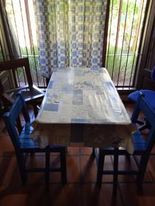 a table with a table cloth on it with two chairs at Hostal El Puesto in Salto