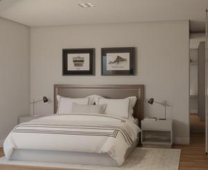 a white bedroom with a large bed and two lamps at Apartamento TOP PraiaBrava in Florianópolis