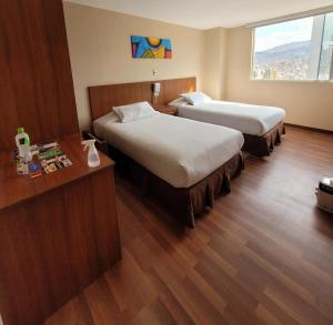 a hotel room with two beds and a window at Hotel Madrid in La Paz +40 photos