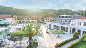 arial view of a resort with a palm tree and buildings at Chrousso Village in Paliouri