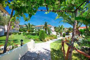 a walkway through the gardens of a villa at Chrousso Village in Paliouri