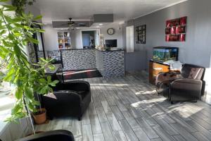 a living room with couches and chairs and a bar at Relax Inn in Marshall