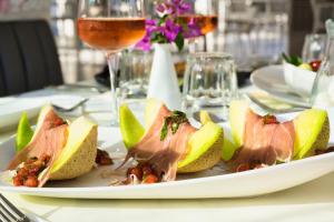 a plate of food on a table with a glass of wine at Chrousso Village in Paliouri