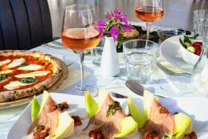 a table with plates of food and glasses of wine at Chrousso Village in Paliouri