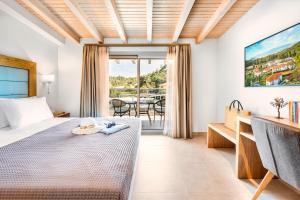 a hotel room with a bed and a table with chairs at Chrousso Village in Paliouri